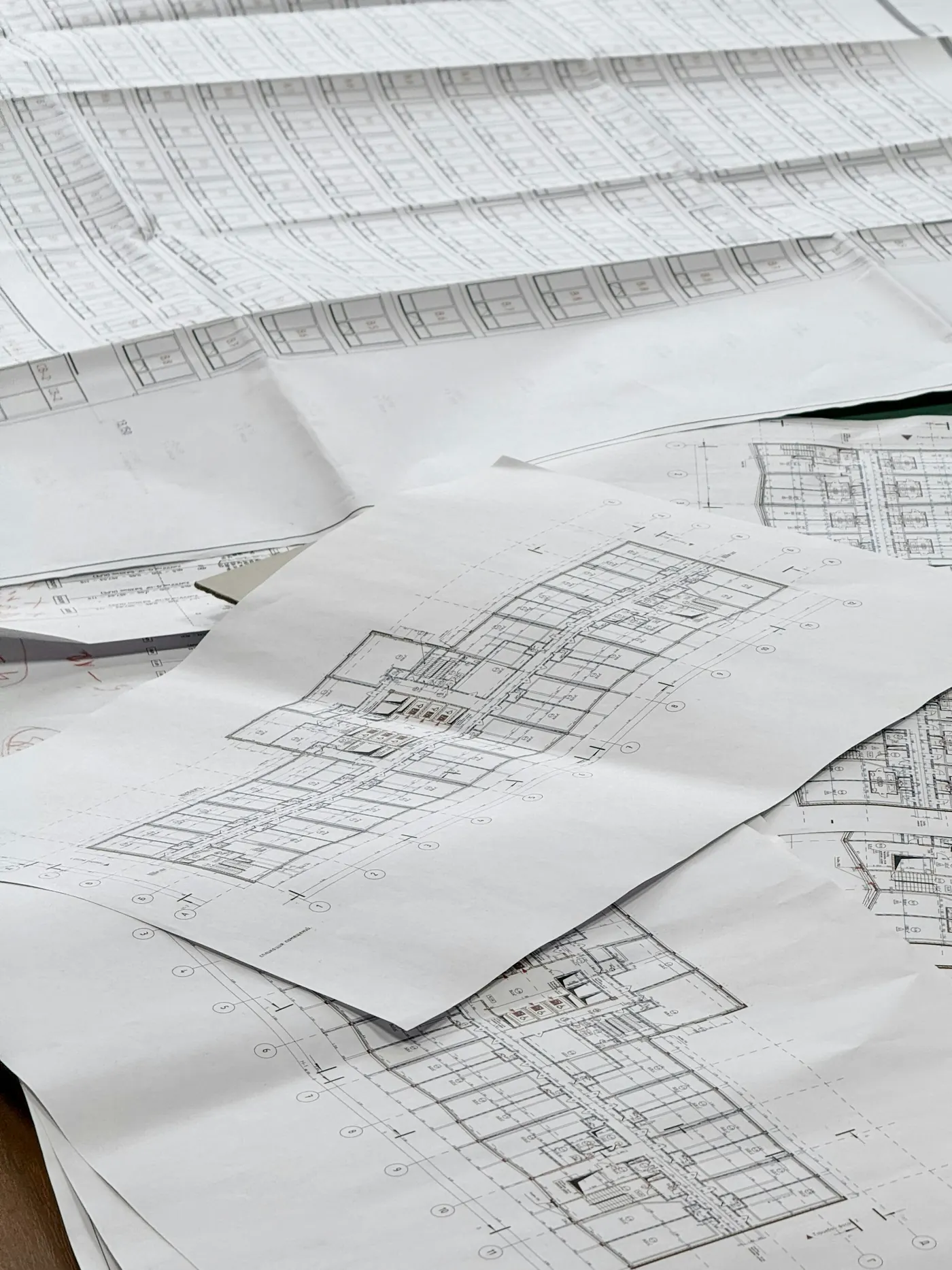 Architectural and engineering drawings spread out across a desk